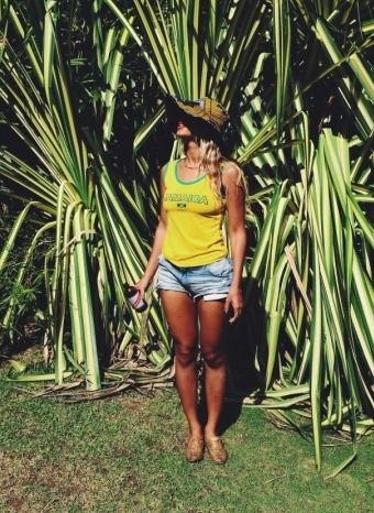 Beyonce in Portland, Jamaica, soaking up some sun with a Red Stripe in hand.